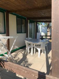 a white table and chairs on a patio at Maronda Camping in Marina di Montenero