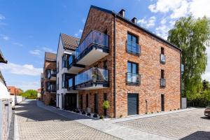 an exterior view of a brick building at Apartamenty na wydmach in Łeba