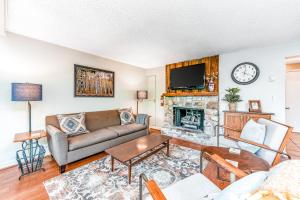 a living room with a couch and a fireplace at The Hemlock Hideaway in Sugar Mountain