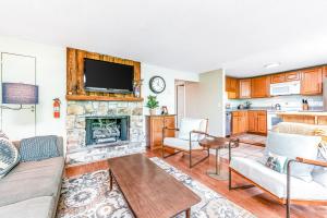 a living room with a couch and a fireplace at The Hemlock Hideaway in Sugar Mountain