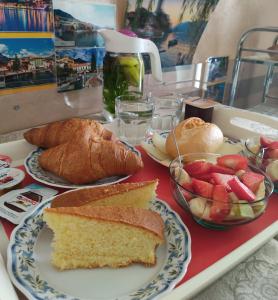 a tray of food with bread and fruit on it at Casa Pepe in Colà di Lazise