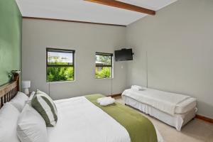 Un pat sau paturi într-o cameră la De Akker Guest House