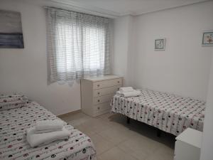 1 dormitorio con 2 camas, vestidor y ventana en Dumar Puerto Rey, en Vera