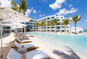 a pool at the resort with lounge chairs and umbrellas at The Morgan Resort Spa & Village in Simpson Bay