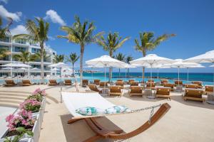 a hammock on the beach with chairs and umbrellas at The Morgan Resort Spa & Village in Simpson Bay +37 photos
