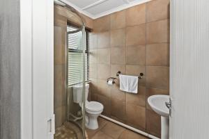 a bathroom with a toilet and a sink at De Akker Guest House in Bloemfontein +50 photos