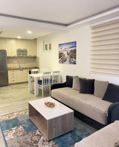 a living room with a couch and a table at Studio apartman Holiday in Tivat