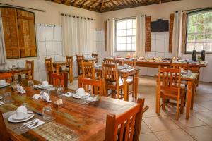 a large dining room with wooden tables and chairs at Solar de Amelia in Tiradentes