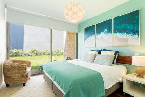 a bedroom with a large bed and a large window at Villa Mar Garajau in Caniço +34 photos