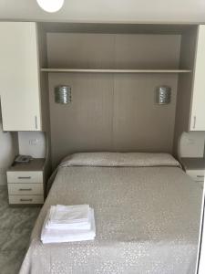 A bed or beds in a room at Hotel Rivamare Only Room Breakfast