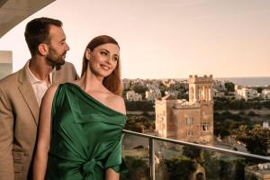 a man and a woman standing on top of a building at Hyatt Regency Malta in St. Julianʼs