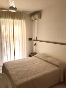 A bed or beds in a room at Hotel Rivamare Only Room Breakfast