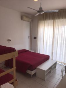A bed or beds in a room at Hotel Rivamare Only Room Breakfast