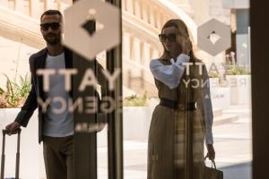 a man and a woman standing next to a sign at Hyatt Regency Malta in St. Julianʼs