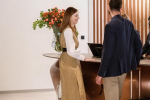a woman standing at a desk with a man at Hyatt Regency Malta in St. Julianʼs