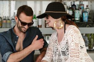 a man standing next to a woman wearing a hat at Hyatt Regency Malta in St. Julianʼs