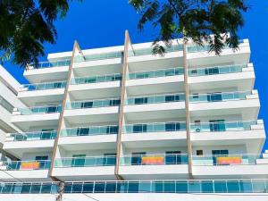 ein Apartmenthaus mit Balkon an der Seite in der Unterkunft Varandão Incrível E Um Deslumbrante Pôr do Sol 304 in Cabo Frio