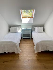 two beds in a room with a window at Haus Gnigl in Salzburg +23 photos