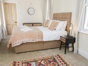 a bedroom with a large bed and a table at Laurel House in Whitby