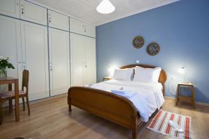 a blue bedroom with a large bed and a table at Guesthouse Simou with view 3 bedrooms in Arachova