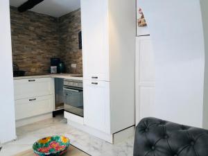 a kitchen with white cabinets and a bowl on a table at Apartment la Grotta Pizzo in Pizzo