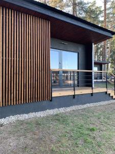 a house with a large window on the side of it at Forest House Augustów in Augustów