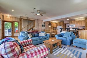 a living room with blue couches and a table at Sunny Providence Cottage Retreat with Dock, Kayaks in Sunrise Beach
