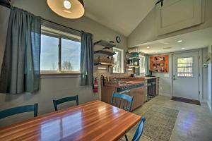 a kitchen with a wooden table and blue chairs at Cozy Hillside Retreat with BBQ, Fire Pit, and Trails! in Milford
