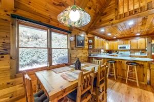 a dining room with a wooden table in a cabin at Lucilles Creekside Hideaway in Blue Ridge