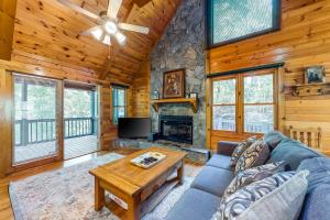 a living room with a couch and a fireplace at Lucilles Creekside Hideaway in Blue Ridge