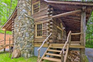 a log cabin with stairs leading up to it at Secluded Cabin with Porch on 39 Acres Ski and Hike in Swiss
