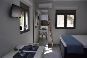a bedroom with a bed and a table in it at Antigonis Garden House in Chania