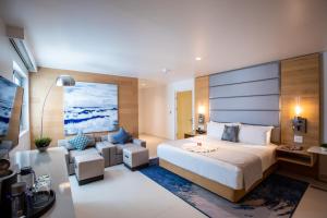 a bedroom with a large bed and a couch at The Morgan Resort Spa & Village in Simpson Bay +65 photos