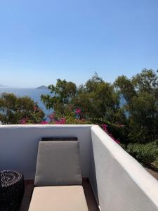 a balcony with a bench and a view of the ocean at PATMOS Confidential in Patmos