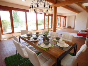 mesa de comedor con sillas blancas y lámpara de araña en 241 Pinon, en Durango