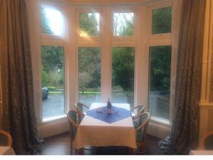 a table and chairs in a room with a window at Balcary House Hotel in Hawick