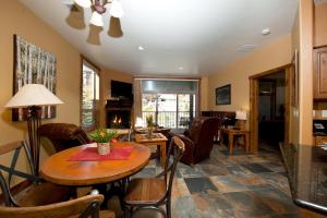 a living room with a table and chairs at Peregrine Point 201 in Durango Mountain Resort