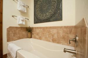 a bath tub in a bathroom with towels on the wall at Peregrine Point 201 in Durango Mountain Resort +18 photos