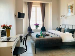 a bedroom with a bed and a desk with a laptop at Apartments Monaco in Monte Carlo