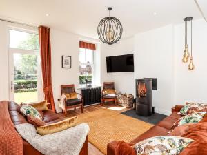 a living room with a couch and a fireplace at Seascape in Annan