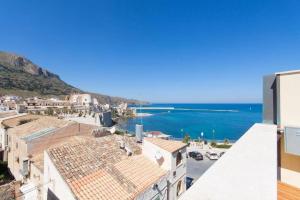 a view of the beach from the roof of a building at La Casa blu sul mare - The Blue house by the sea in Castellammare del Golfo