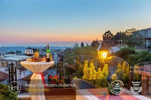 a balcony with a table and two bottles of wine at Best Point Suites Old City - Best Group Hotels in Istanbul