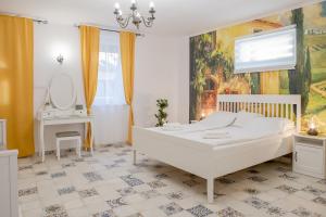 Postel nebo postele na pokoji v ubytování Jázmin Apartman