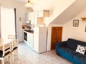 a kitchen and a living room with a couch and a table at Pausa mare Ponza - Immobilevante in Ponza