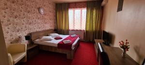 Voodi või voodid majutusasutuse Hotel Olimp toas