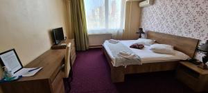 Voodi või voodid majutusasutuse Hotel Olimp toas