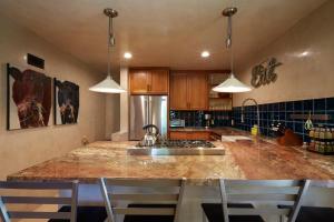 a kitchen with a counter and a stove top oven at 101 Llano Largo in Santa Fe