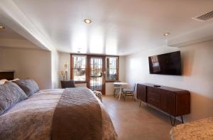 a bedroom with a large bed and a television at 101 Llano Largo in Santa Fe
