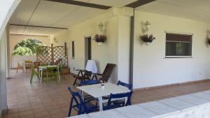 a patio with chairs and tables and a table at Cara Pace in collina per gruppi in Montefiore Conca