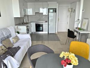 a living room with a couch and a table at POSTIGUET BEACH in Alicante +11 photos